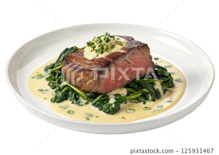Seared Steak with Creamy Spinach Sauce on a White Plate Seared Steak with Creamy Spinach Sauce on a White Plate 125931467