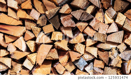 A pile of wood with many pieces of wood stacked on top of each other 125931474