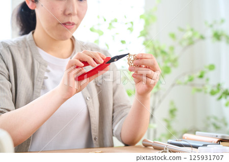 Woman making handmade accessories 125931707