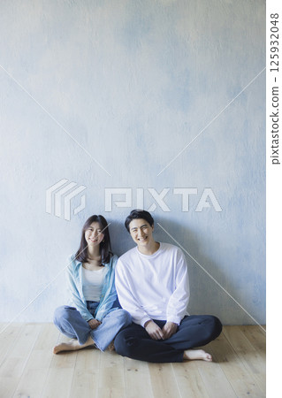 A couple sitting side by side 125932048