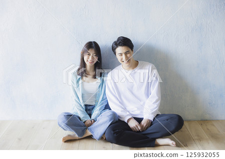 A couple sitting side by side 125932055