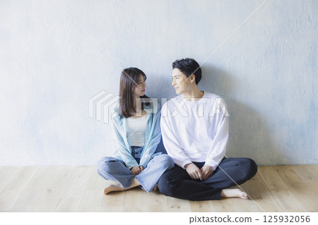 A couple sitting side by side 125932056