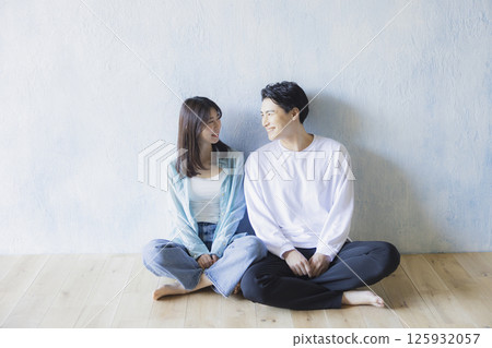 A couple sitting side by side 125932057