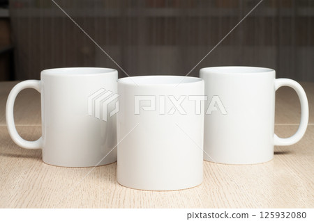 Three Blank 11oz white mugs on on the table. Mugs mockup Three Blank 11oz white mugs on on the table. Mugs mockup 125932080