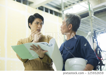 Site supervisors discussing plans at the site Site supervisors discussing plans at the site 125932659