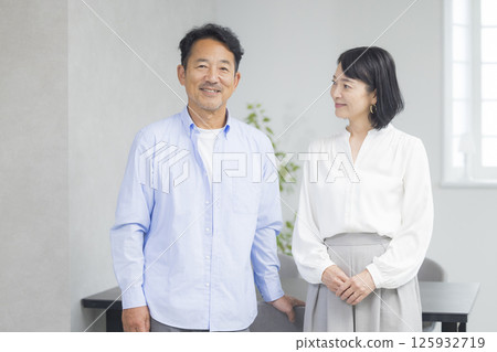 A smiling couple standing side by side A smiling couple standing side by side 125932719