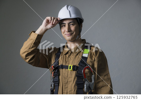 Male worker wearing a full harness Male worker wearing a full harness 125932765
