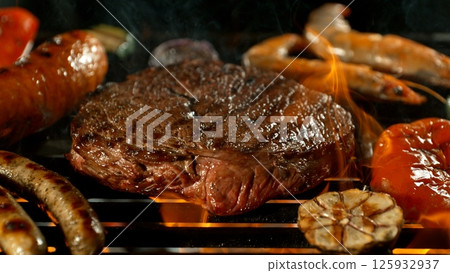 Close-up of Beef Steak on a Grill with Roaring Flames 125932937