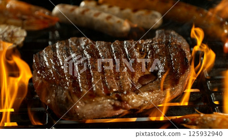 Close-up of Beef Steak on a Grill with Roaring Flames Close-up of Beef Steak on a Grill with Roaring Flames 125932940
