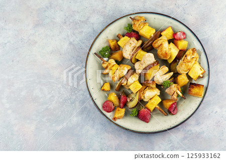 Chicken meat with pineapple on skewers. Chicken meat with pineapple on skewers. 125933162