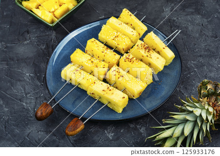 Pineapple chunks on wooden sticks. Pineapple chunks on wooden sticks. 125933176