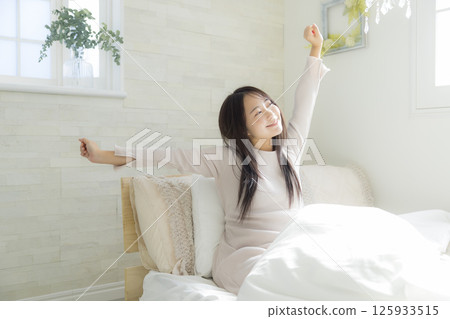 Woman getting up in bed 125933515