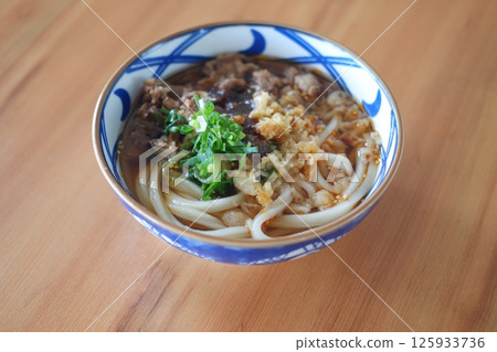 a beautifully presented bowl of Japanese udon noodles in a savory broth a beautifully presented bowl of Japanese udon noodles in a savory broth 125933736