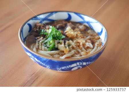 a beautifully presented bowl of Japanese udon noodles in a savory broth a beautifully presented bowl of Japanese udon noodles in a savory broth 125933737