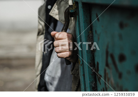 The worker's hands, covered with sweat and dust, demonstrate endless determination. The worker's hands, covered with sweat and dust, demonstrate endless determination. 125933859