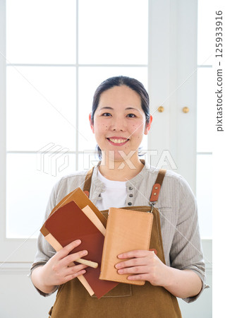A woman making handmade leather products - Leather craft A woman making handmade leather products - Leather craft 125933916