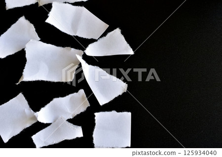 Numerous scraps of white paper. 125934040
