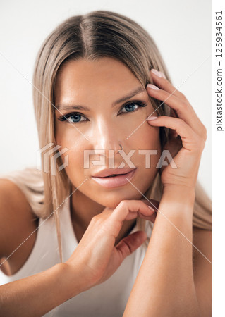 Close-up portrait of a woman with long hair and blue eyes expressing confidence Close-up portrait of a woman with long hair and blue eyes expressing confidence 125934561