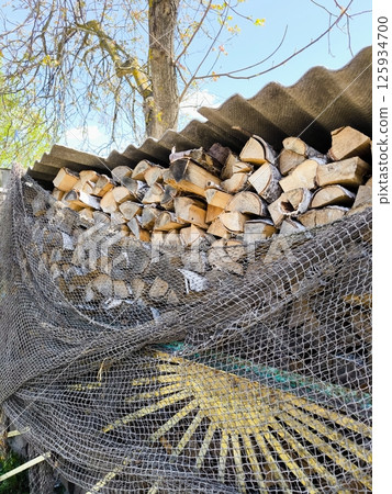 Set of cut firewood. Piles of firewood Firewood stack. A woodpile in the yard. Set of cut firewood. Piles of firewood Firewood stack. A woodpile in the yard. 125934700
