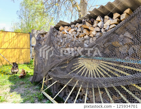Set of cut firewood. Piles of firewood Firewood stack. A woodpile in the yard. Set of cut firewood. Piles of firewood Firewood stack. A woodpile in the yard. 125934701