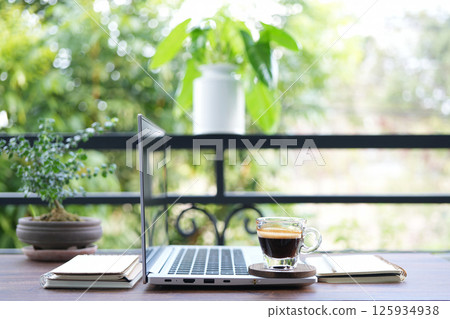 chilling balcony workspace with coffee drink and laptop chilling balcony workspace with coffee drink and laptop 125934938