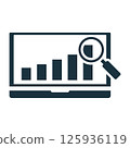 Magnifying glass analyzing growing bar graph on laptop screen 125936119