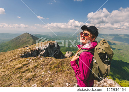 Female Traveler with Backpack Hiking in Mountains Female Traveler with Backpack Hiking in Mountains 125936464