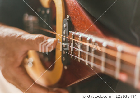 Close up hand playing Thai Mandolin Close up hand playing Thai Mandolin 125936484