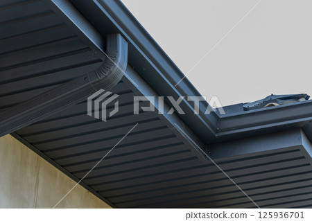 Close-up view showcases a contemporary roof edge with a smooth finish, highlighting architectural details in bright sunlight 125936701