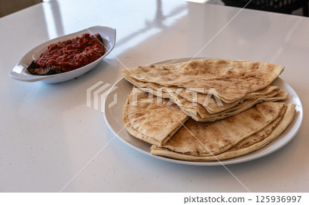 Traditional flatbread, lavash, wheaten pita flat bread or flatbread also known as pita bread 125936997