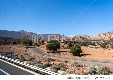 Morocco semi-deserts and mountains, north africa nature, Moroccan stone desert, red hills, villages and argan trees 125936998