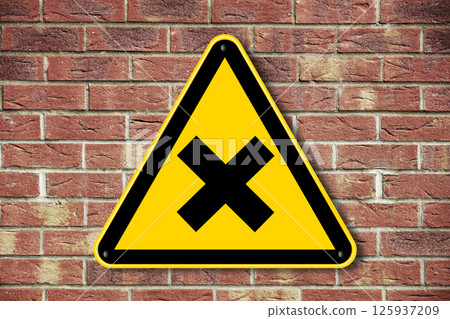 Caution warning sign on a brick wall background Caution warning sign on a brick wall background 125937209