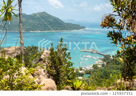 Scenic view from the hill on Praslin Island overlooking Baie Sainte Anne with boats 125937351