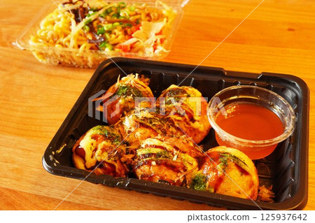 Large, soft and freshly baked takoyaki balls purchased from a food truck at the festival. Large, soft and freshly baked takoyaki balls purchased from a food truck at the festival. 125937642