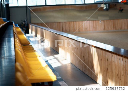 A grandstand at a hippodrome for horse racing. Rows of seats in a stadium 125937732