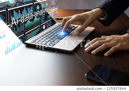 Businessman uses AI program to analyze data 125937844
