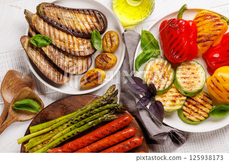 Assorted grilled vegetables including bell peppers, zucchini, eggplant, and sausages Assorted grilled vegetables including bell peppers, zucchini, eggplant, and sausages 125938173