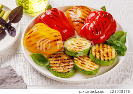 Assorted grilled vegetables including bell peppers, zucchini, and fresh herbs Assorted grilled vegetables including bell peppers, zucchini, and fresh herbs 125938176