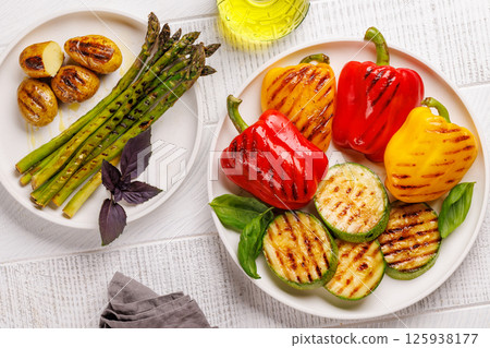 Assorted grilled vegetables including bell peppers, zucchini, eggplant, and asparagus 125938177