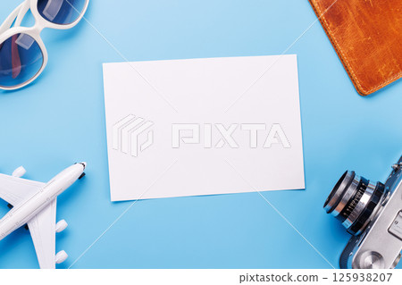 Travel-themed flat lay with blank photo card, camera, toy airplane Travel-themed flat lay with blank photo card, camera, toy airplane 125938207