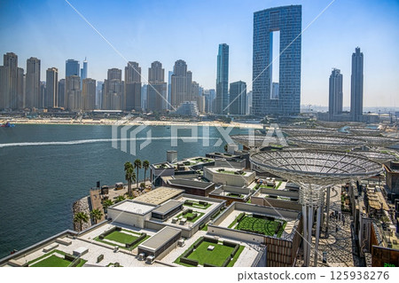 Dubai beach with highrise skyline and clear sea water 125938276