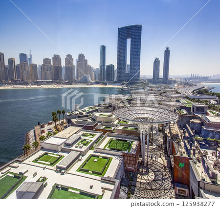 Dubai beach with highrise skyline and clear sea water 125938277