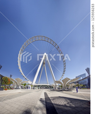 Dubai Eye giant Ferris wheel under blue sky Dubai Eye giant Ferris wheel under blue sky 125938283