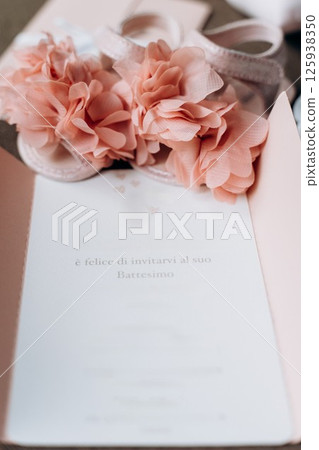Baptism Invitation with Pink Baby Shoes and Flowers 125938350