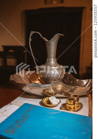 Baptismal Accessories on Table for Ceremony Preparation 125938357