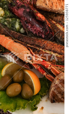 Grilled fish platter featuring shrimp, tuna, and octopus in croatia 125938771