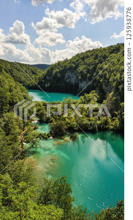 Breathtaking turquoise waterfalls flowing through lush green forest in plitvice lakes national park 125938776