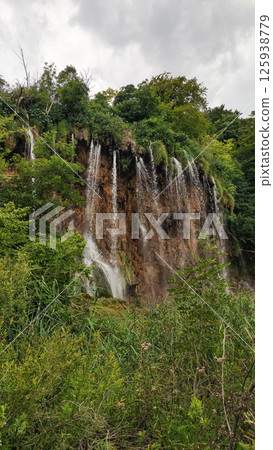 Waterfalls flowing down cliffside in plitvice lakes national park 125938779