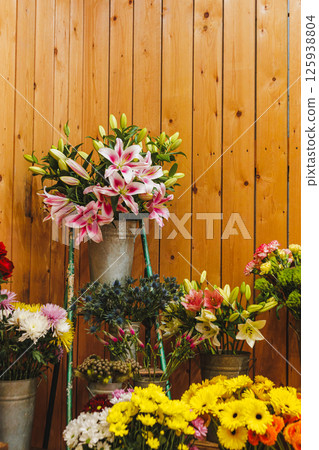 Lilies, gerberas, and other colorful flowers displayed on a wooden ladder in a flower shop, Mothers day 125938804