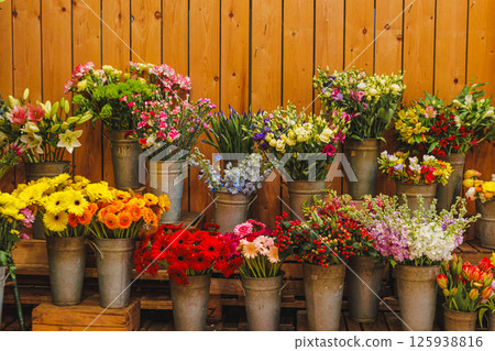 Colorful flower bouquets in metal buckets at flower shop, Mothers day 125938816
